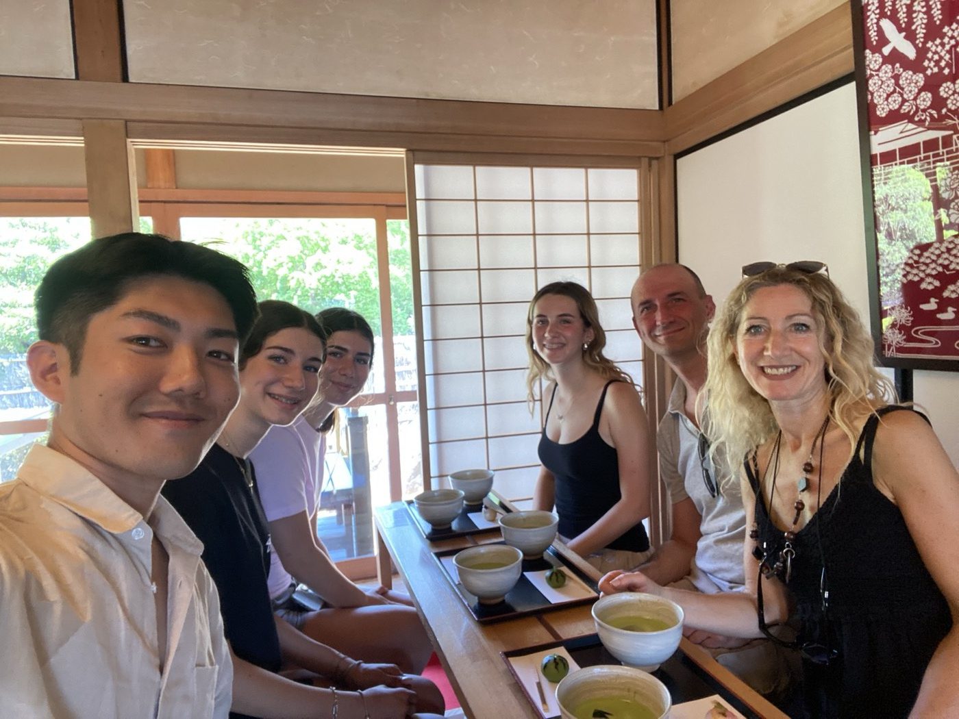 Guests enjoying a traditional matcha tea ceremony with local guide Yuki
